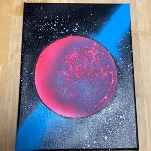 homemade spray paint picture. Pink and blue planet, black starry background.